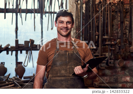 Happy, metal worker and portrait in workshop with clipboard for manufacturing, welding and blacksmith. Tradesman, smiling and confident in factory with tools for artisan, craftsman and manual labor Happy, metal worker and portrait in workshop with clipboard for manufacturing, welding and blacksmith. Tradesman, smiling and confident in factory with tools for artisan, craftsman and manual labor 142833322
