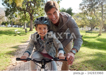 Father, girl and happy outside on bicycle in nature, support and help for teaching and motor skills for growth. Childhood, development and family in park, bonding and helmet for riding with parent Father, girl and happy outside on bicycle in nature, support and help for teaching and motor skills for growth. Childhood, development and family in park, bonding and helmet for riding with parent 142833960
