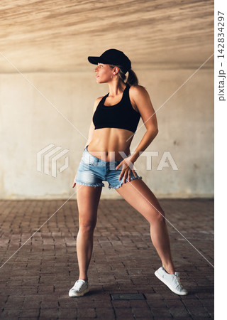 Girl, dancer and fitness with fashion in city with dancing for practice, routine and rehearsal with streetwear. Artist, person and energy for movement with wellness, muscle and skill for hip hop 142834297