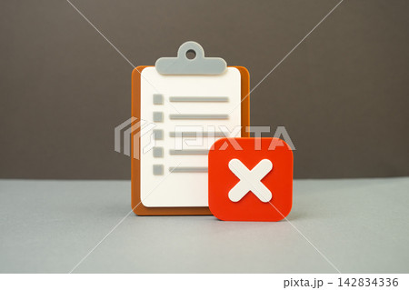 A paper tablet and a rejection sign. Test failed, inspection failed. Denial of hiring or employment. Concept of setbacks and unsuccessful job applications today. 142834336