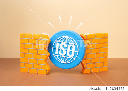 An ISO symbol breaking through a wall. Implementation of new rules and standards. Concept of quality certification and regulatory transformation in business. Progress ahead. An ISO symbol breaking through a wall. Implementation of new rules and standards. Concept of quality certification and regulatory transformation in business. Progress ahead. 142834381