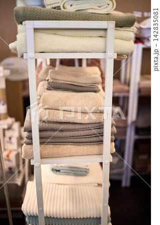 Neatly Folded Towels on Storage Rack Display Neatly Folded Towels on Storage Rack Display 142835081