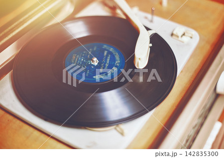 Vinyl record, spinning on a turntable, Vintage record player with radio 60's. Vinyl record, spinning on a turntable, Vintage record player with radio 60's. 142835300