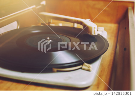 Vinyl record, spinning on a turntable, Vintage record player with radio 60's. 142835301