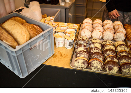 Assorted Fresh Pastries Display - Croissants, Donuts, and Baked Goods at Market Assorted Fresh Pastries Display - Croissants, Donuts, and Baked Goods at Market 142835565