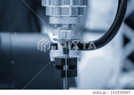 Close-up of an automotive valve assembly process by a robotic system in a blue tone scene Close-up of an automotive valve assembly process by a robotic system in a blue tone scene 142838007