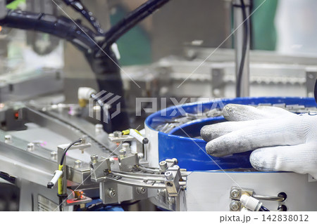 Hand of a mechanic performing maintenance on an automation production line Hand of a mechanic performing maintenance on an automation production line 142838012