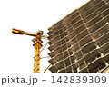 A multi-story building under construction with a tower crane isolated on transparent background, looking up. Residential construction, real estate investment at the construction stage 142839309