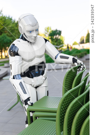 Close-up modern robot working with terrace furniture Close-up modern robot working with terrace furniture 142839347