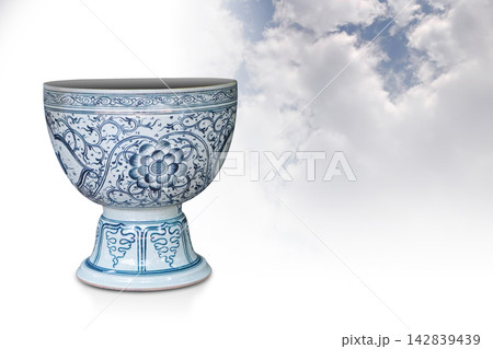 front view antique white and blue large ceramic pot on white and blue large ceramic stand on blue sky and white cloud background, vintage, nature, ancient, object, decor, copy space 142839439
