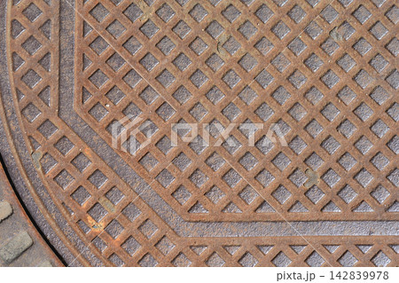 Rusty cast iron manhole cover texture 142839978