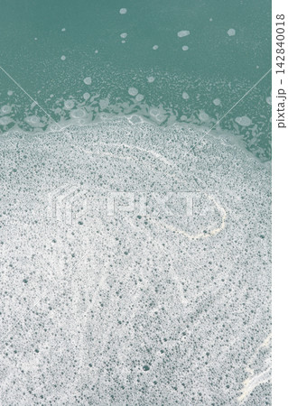 White sea foam texture on green water White sea foam texture on green water 142840018