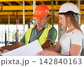 Builder tells lady expert about peculiarities of work process 142840163