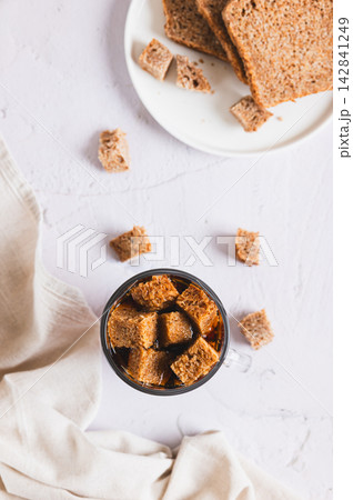 Traditional fermented rye bread kvass in a glass on the table top and vertical view Traditional fermented rye bread kvass in a glass on the table top and vertical view 142841249
