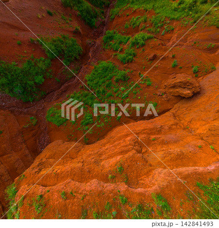 Aerial View of Eroded Landscape with Red Soil and Green Vegetation Aerial View of Eroded Landscape with Red Soil and Green Vegetation 142841493
