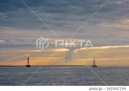 Yachtsmen are sitting amicably on board the boat at incredible sunset, sailing boat is in sailing regatta in the Gulf of Finland, magic splashing water, teamwork, Russia, St.Petersburg Yachtsmen are sitting amicably on board the boat at incredible sunset, sailing boat is in sailing regatta in the Gulf of Finland, magic splashing water, teamwork, Russia, St.Petersburg 142842134