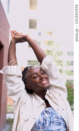 Smiling Young Woman Stretching with Eyes Closed, Relaxation, Morning Energy, Mindfulness, Wellness and Healthy Lifestyle 142842956