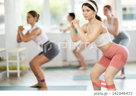Training leg muscles and using resistance bands in Pilates classes for women Training leg muscles and using resistance bands in Pilates classes for women 142846472