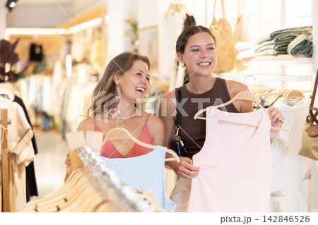 Two young women choosing blouse in clothing store 142846526