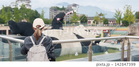 Happy woman traveler travel in Dujiangyan city. Tourist sightseeing Yangtianwo Square and Guanxian Ancient City near Chengdu. Landmark and popular for tourism attraction in Sichuan, China Happy woman traveler travel in Dujiangyan city. Tourist sightseeing Yangtianwo Square and Guanxian Ancient City near Chengdu. Landmark and popular for tourism attraction in Sichuan, China 142847399