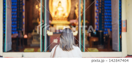 woman traveler travel in Chengdu city. Happy Tourist sightseeing in Daci Temple is a Buddhist temple . Famous Landmark for tourism attraction in Sichuan, China 142847404