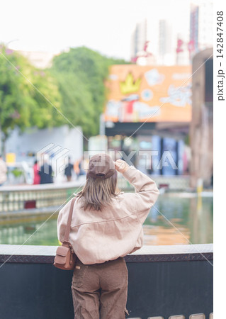 Happy woman traveler travel in Chengdu city. Tourist sightseeing and shopping in Eastern Suburb Memory or Dongjiao Ji Yi. Famous Landmark for tourism attraction in Sichuan, China 142847408