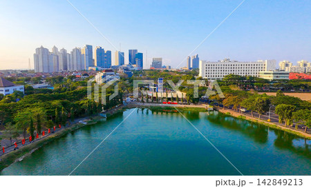 Panoramic view of Danau UNESA lake surrounded by green trees and city skyline in Surabaya East Java. Panoramic view of Danau UNESA lake surrounded by green trees and city skyline in Surabaya East Java. 142849213