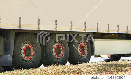 Delivering.Wheels of heavy trailer for long distance transportation Delivering.Wheels of heavy trailer for long distance transportation 142850044