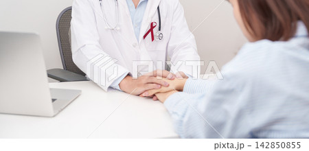 doctor holding patient hand to comfort and support with empathy. burgundy ribbon concept of March Multiple Myeloma Cancer Awareness month, September Sickle Cell Anemia, Headache and Migraine week 142850855
