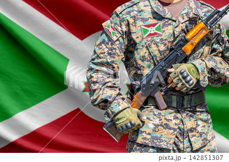 Burundi flag with soldier holding assault rifle Burundi flag with soldier holding assault rifle 142851307