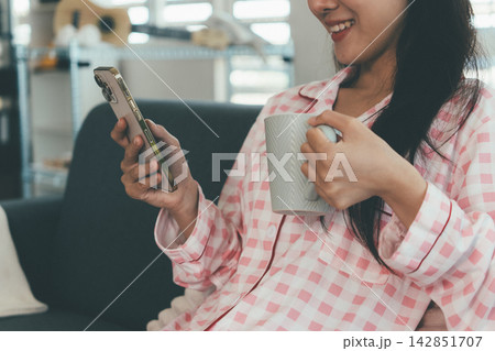 Woman enjoying life at home, promoting healthy eating, wellness, and a balanced lifestyle. Concept of natural nutrition, mindfulness, and modern healthy living. Woman enjoying life at home, promoting healthy eating, wellness, and a balanced lifestyle. Concept of natural nutrition, mindfulness, and modern healthy living. 142851707