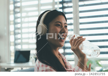 Woman enjoying life at home, promoting healthy eating, wellness, and a balanced lifestyle. Concept of natural nutrition, mindfulness, and modern healthy living. Woman enjoying life at home, promoting healthy eating, wellness, and a balanced lifestyle. Concept of natural nutrition, mindfulness, and modern healthy living. 142851735