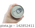 A hand holds a closed metal can 142852411