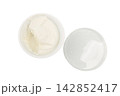 A top-down view of a white plastic container of cream cheese 142852417
