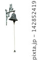 owl figurine is mounted on a wall and holds a tarnished bell with a rope pull. 142852419