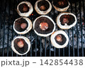 Seasoned portobello mushrooms grilling over hot coals Seasoned portobello mushrooms grilling over hot coals 142854438