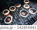 Seasoned portobello mushrooms grilling over hot coals Seasoned portobello mushrooms grilling over hot coals 142854441