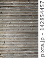 Aged wood wall panels featuring detailed grain patterns and vintage rustic wooden surface texture Aged wood wall panels featuring detailed grain patterns and vintage rustic wooden surface texture 142854457