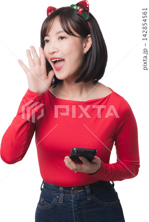 Happy excited asian woman shouting announcement holding smartphone promoting christmas sale event wearing red shirt headband isolated on transparency background Happy excited asian woman shouting announcement holding smartphone promoting christmas sale event wearing red shirt headband isolated on transparency background 142854561
