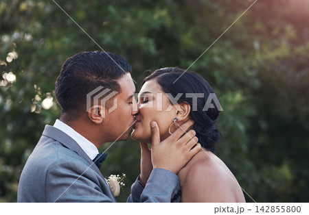 Happy, couple and kiss on wedding day as celebration for love, commitment and success on marriage. Ceremony, woman and man at event as engagement reception together, support and care in sunshine Happy, couple and kiss on wedding day as celebration for love, commitment and success on marriage. Ceremony, woman and man at event as engagement reception together, support and care in sunshine 142855800