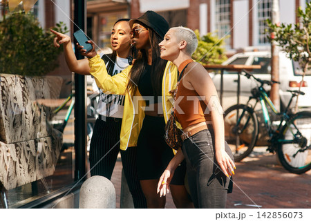 Friends, street and women in city for window shopping for vacation, holiday and travel together on weekend. Happy, fashion and people by shop or retail store in town for bonding, fun and explore Friends, street and women in city for window shopping for vacation, holiday and travel together on weekend. Happy, fashion and people by shop or retail store in town for bonding, fun and explore 142856073