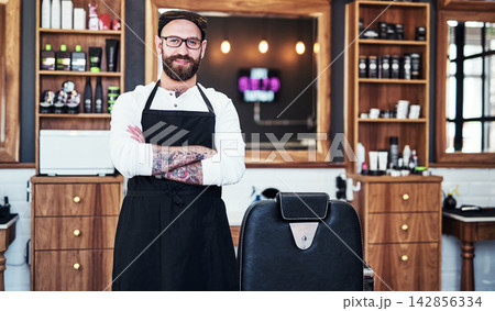 Barber, portrait and hair salon with arms crossed, hairdresser and beauty professional in small business. Barbershop, workplace and man with smile and confidence for haircut and styling service Barber, portrait and hair salon with arms crossed, hairdresser and beauty professional in small business. Barbershop, workplace and man with smile and confidence for haircut and styling service 142856334
