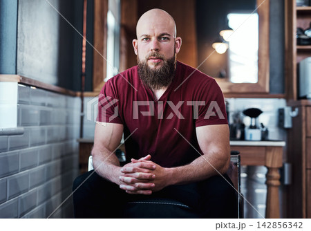Barbershop and man for serious portrait in chair, small business and owner with vision for grooming service. Haircare, facial maintenance and job with confident male person, professional and career 142856342