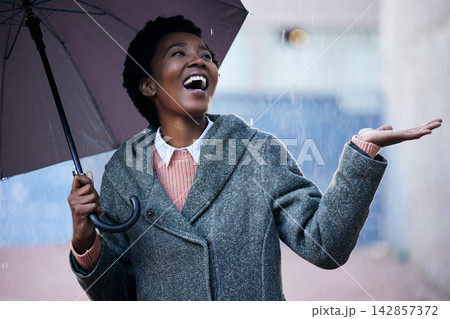 Rain, smile and African businesswoman with umbrella for cover and happiness in city with travel for work. Water, weather and female person in street for insurance, career and walking in winter Rain, smile and African businesswoman with umbrella for cover and happiness in city with travel for work. Water, weather and female person in street for insurance, career and walking in winter 142857372