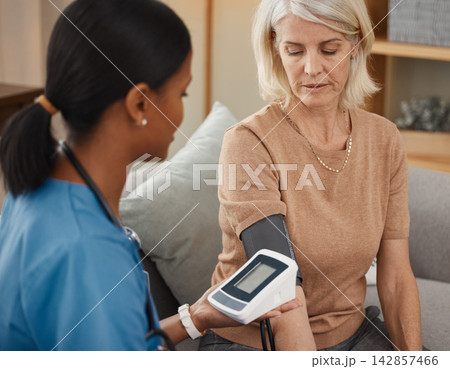 People, nurse and blood pressure machine in cardiovascular, healthcare or wellness with happiness. Mature woman, medic and check for support, medicine or results as professional in clinic or hospital 142857466