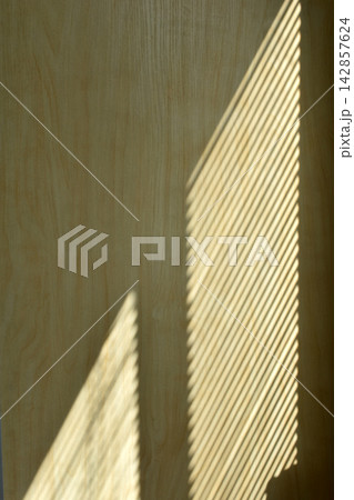 Projection of blinds onto a wooden surface. Projection of blinds onto a wooden surface. 142857624