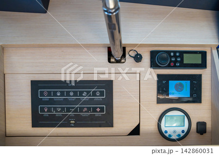 Electrical control panel inside a modern sailing yacht cockpit. Marine onboard monitoring and power management system for safe navigation and vessel operation. 142860031