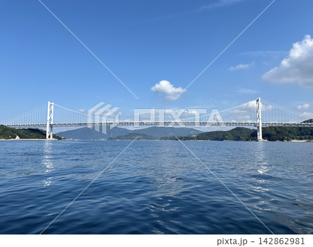 青空と瀬戸内海に架かる因島大橋の全景（しまなみ海道・因島・向島・尾道・吊り橋・インフラ・背景素材） 142862981