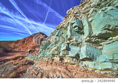 Green Rock Formation and Red Desert Landscape Under Blue Sky in Nevada Green Rock Formation and Red Desert Landscape Under Blue Sky in Nevada 142864040