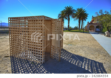 Old Wooden Jail Cell Historical Landmark and Palm Trees in Mojave Desert California Old Wooden Jail Cell Historical Landmark and Palm Trees in Mojave Desert California 142864354